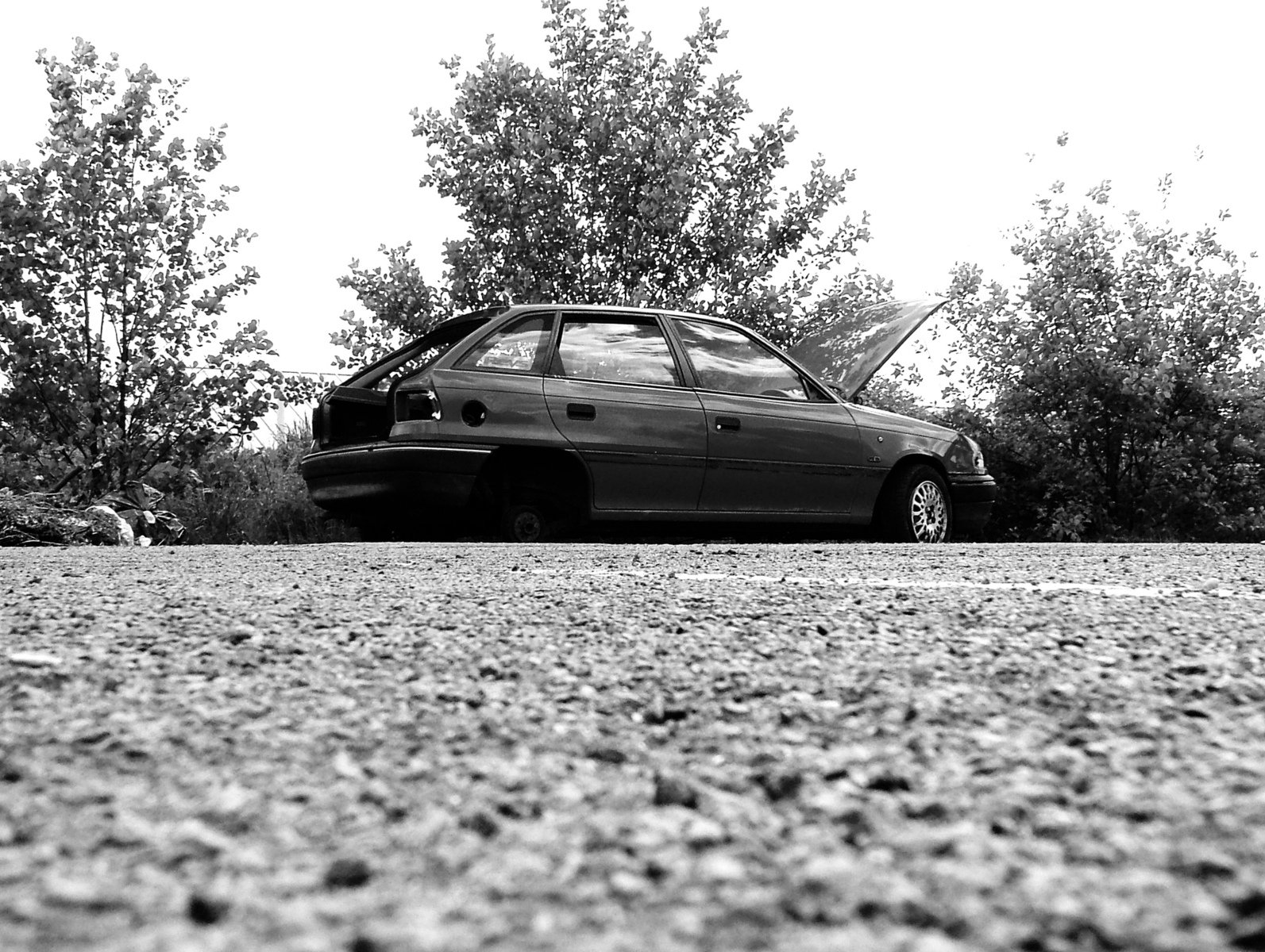 black and white po of a car parked on asphalt