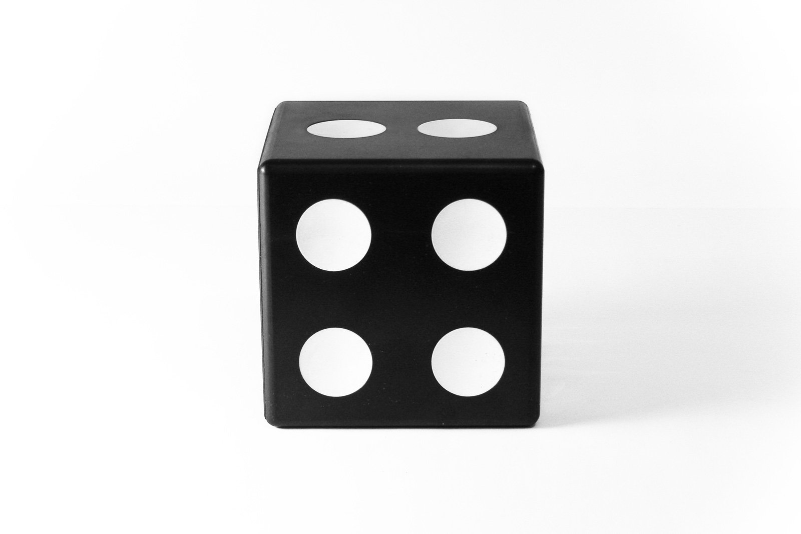 a black and white dice has four dots