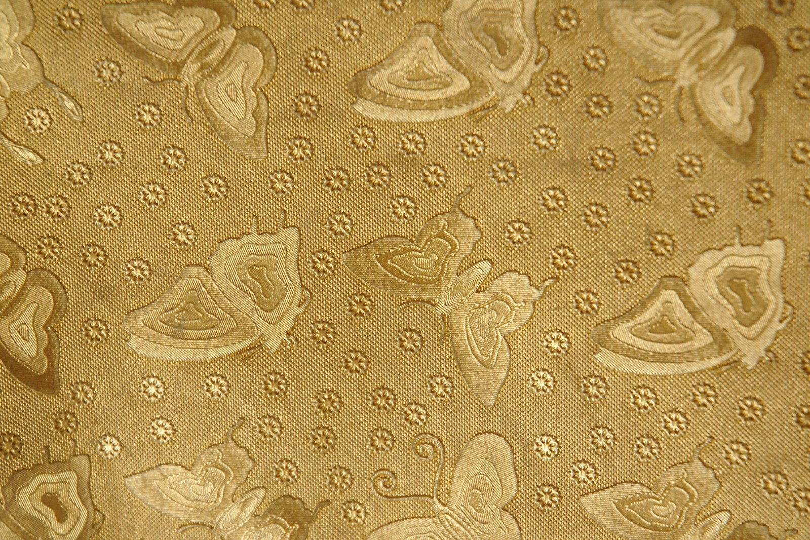 a golden wallpaper with ornate designs on it