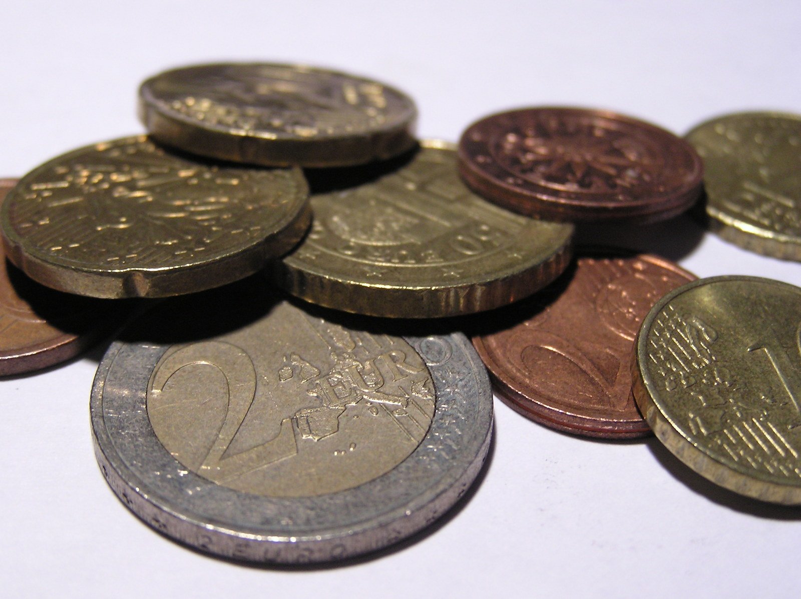 a pile of one coin is shown on a white table