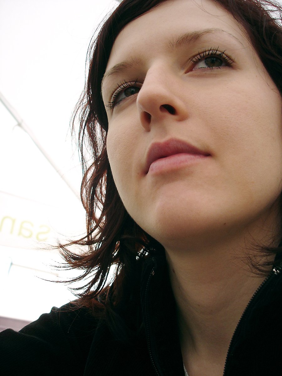 a close up of a woman under an umbrella