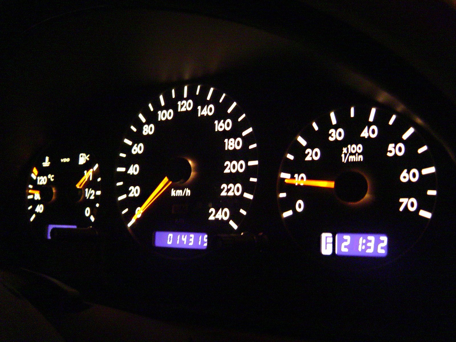 the instruments in the dashboard are illuminated by blue numbers