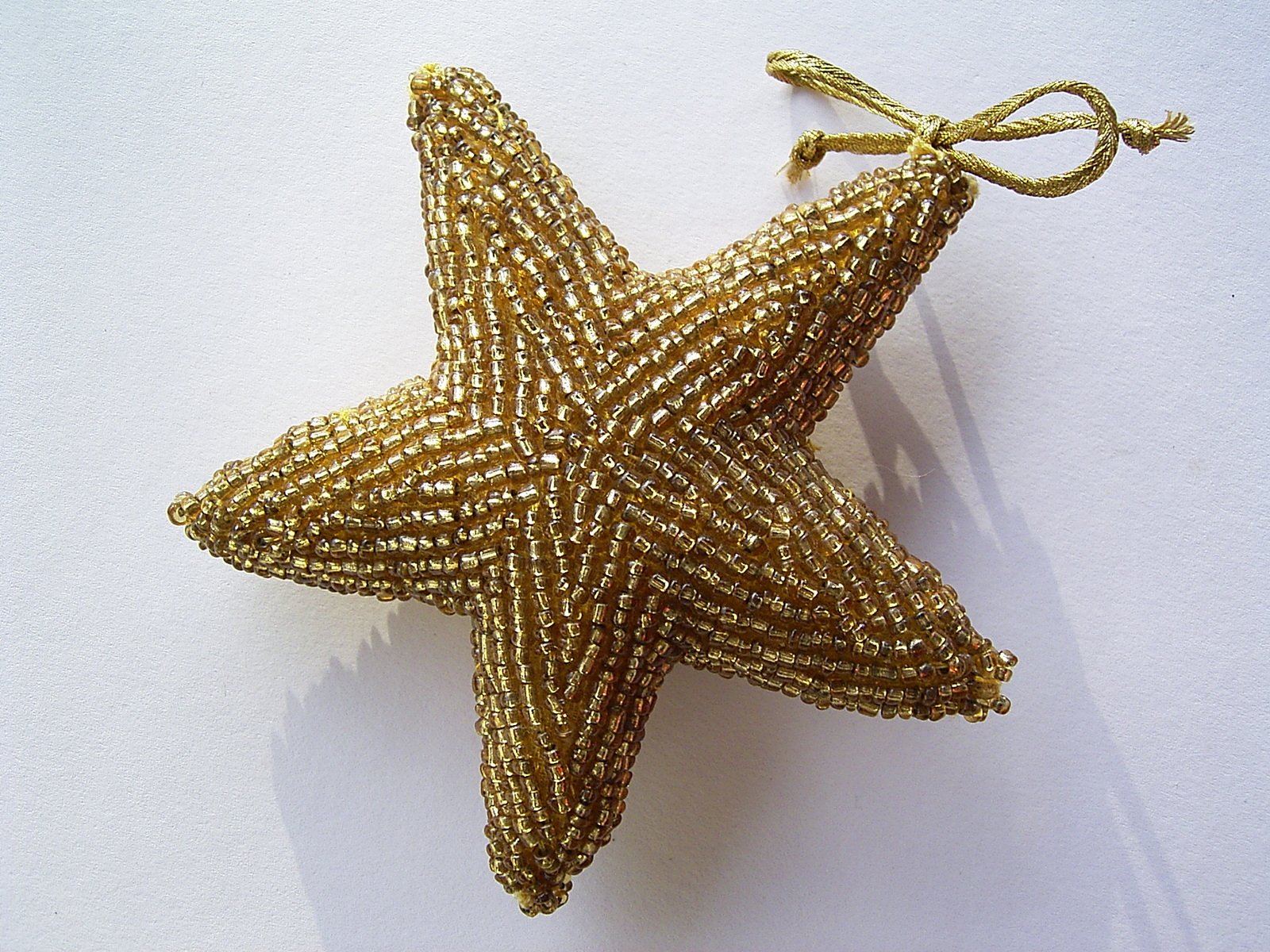 a gold ornament that is hanging on the wall