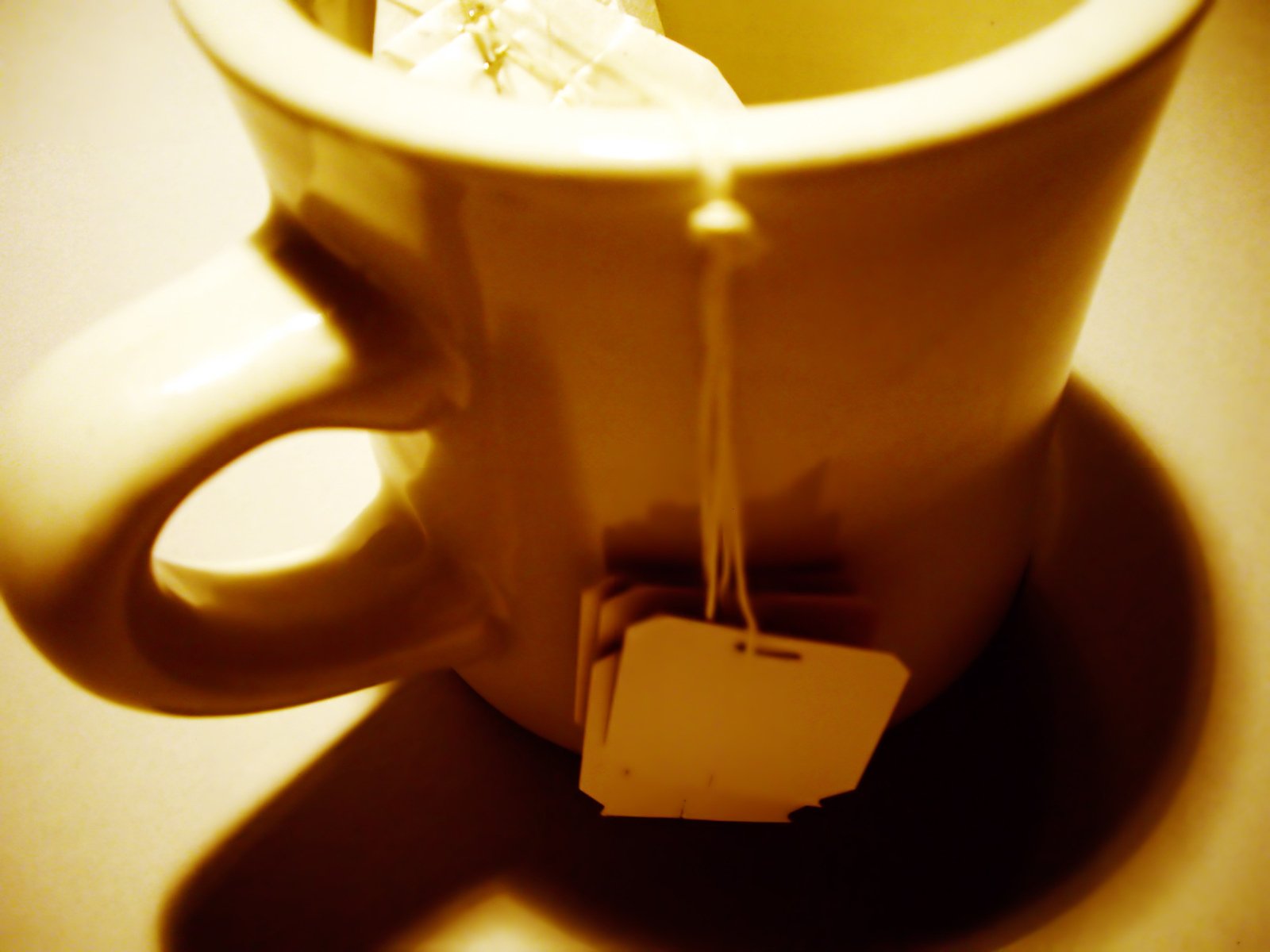 a mug with a piece of paper tied to the inside