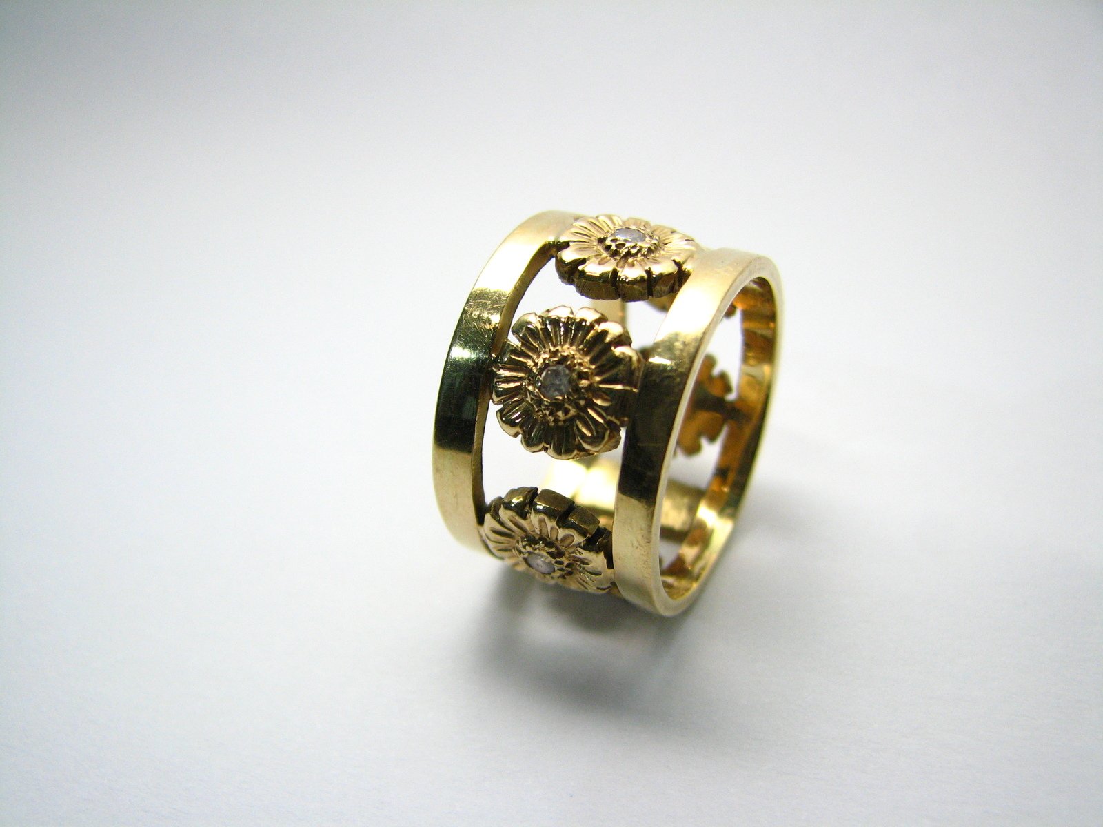 a gold band has flowers on it