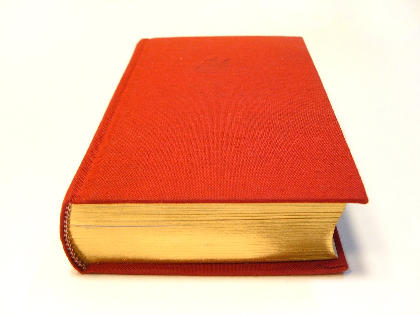 the cover of a red book with gold trim
