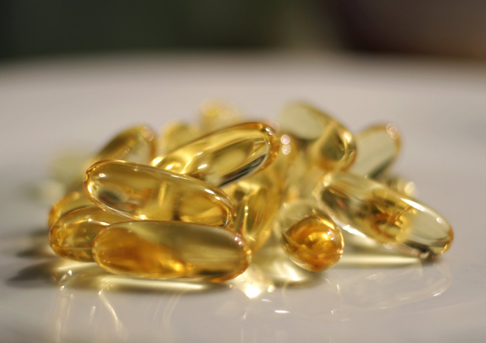 a pile of fish oil capsules sitting on top of a table