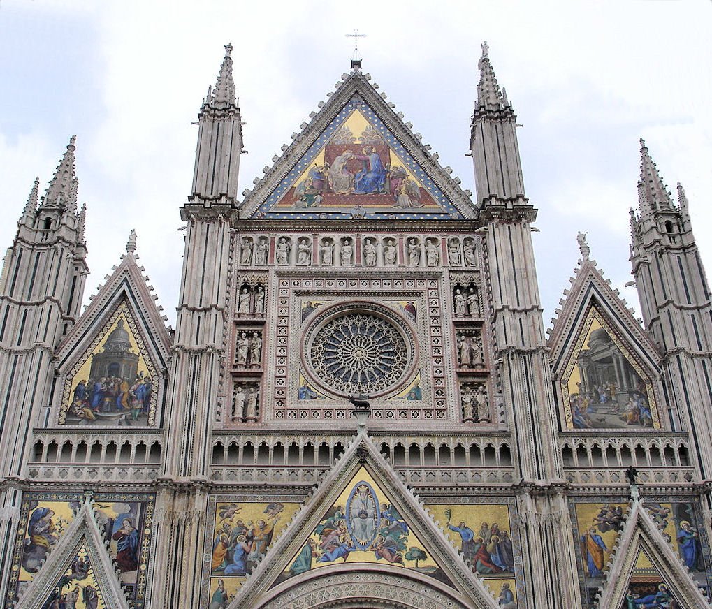 the front of an elaborately designed church with a large stained glass window