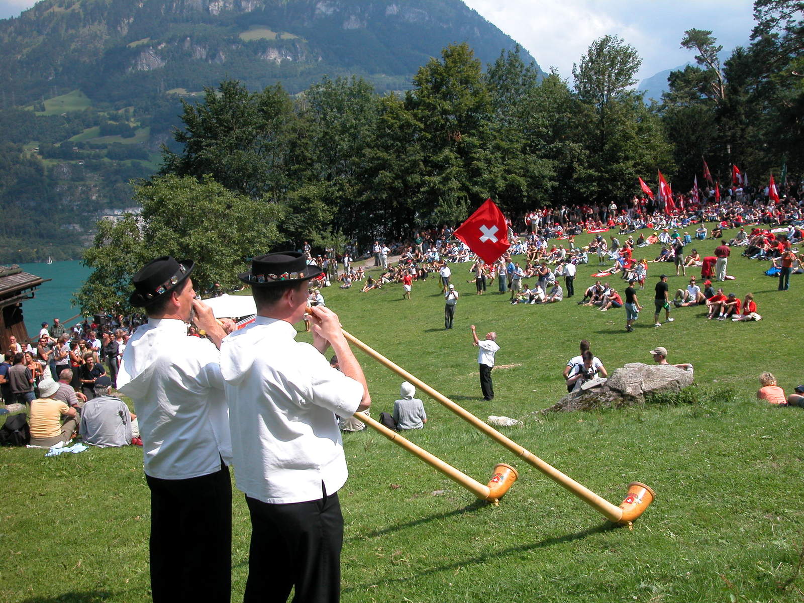 a crowd is gathered in a field with lots of people