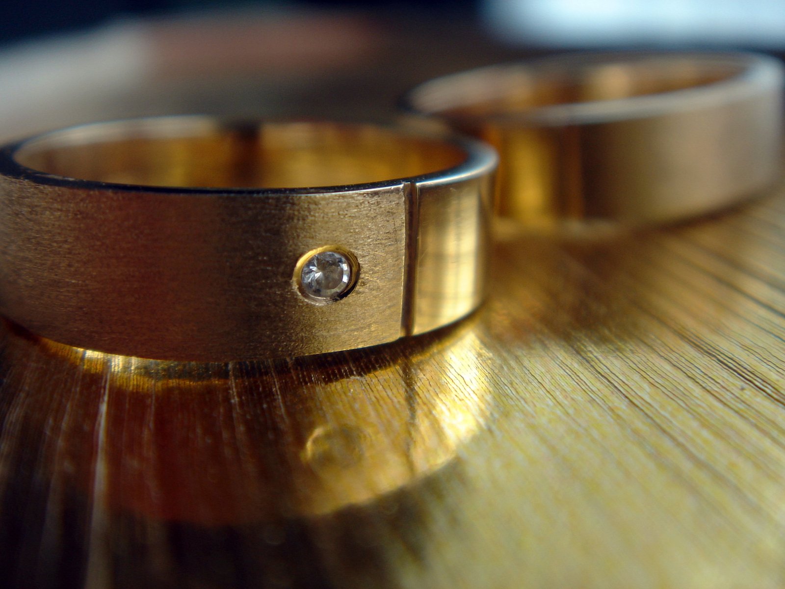 close up of two wedding rings with a diamond on it