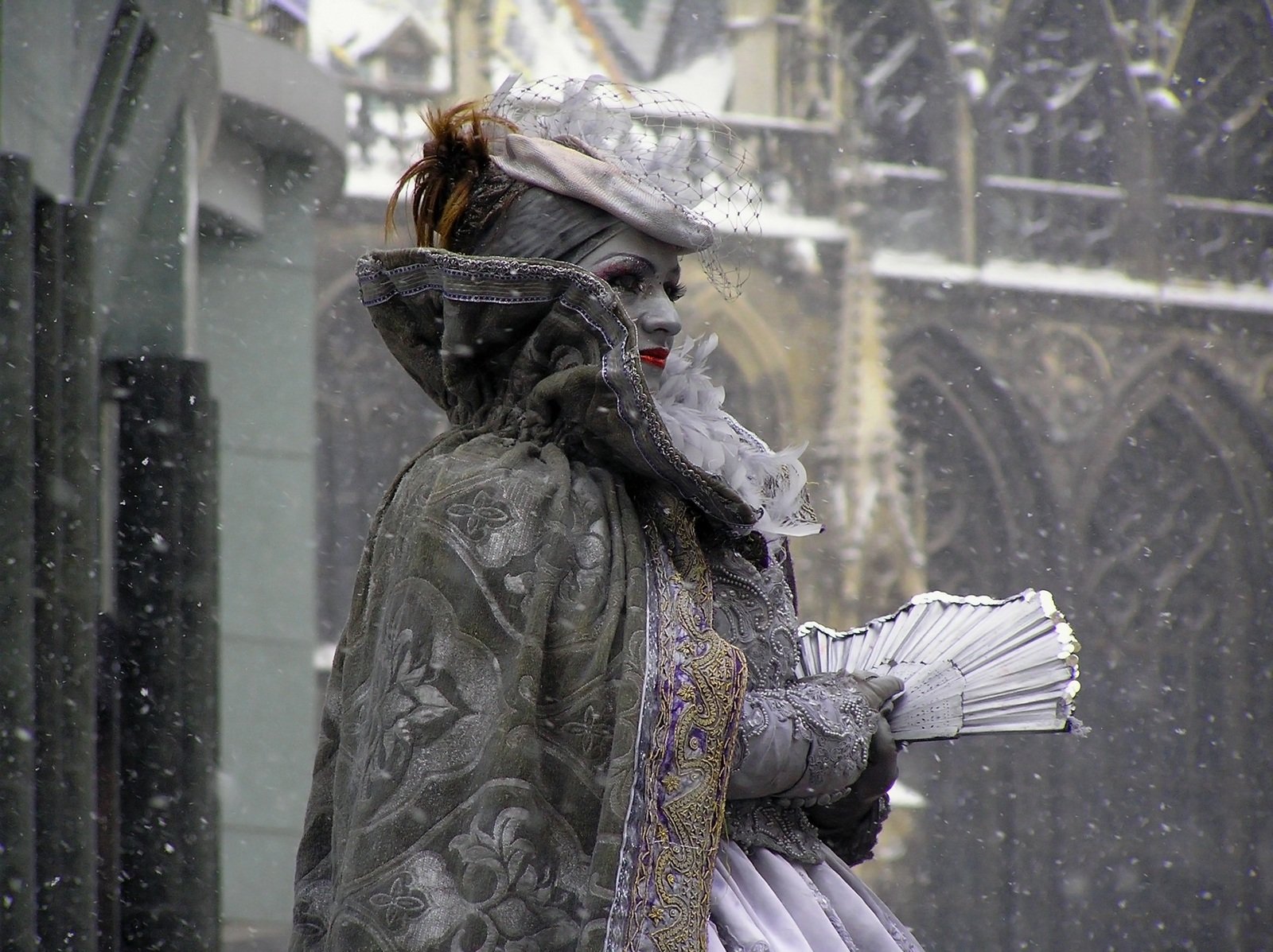 a man wearing a costume and holding an umbrella