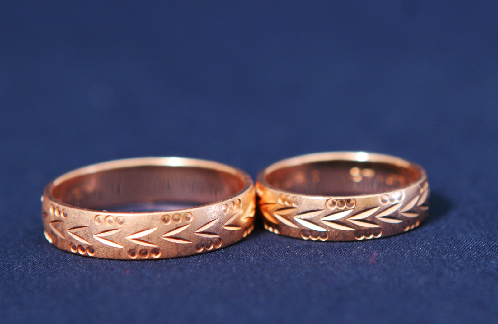 two wedding rings on top of each other