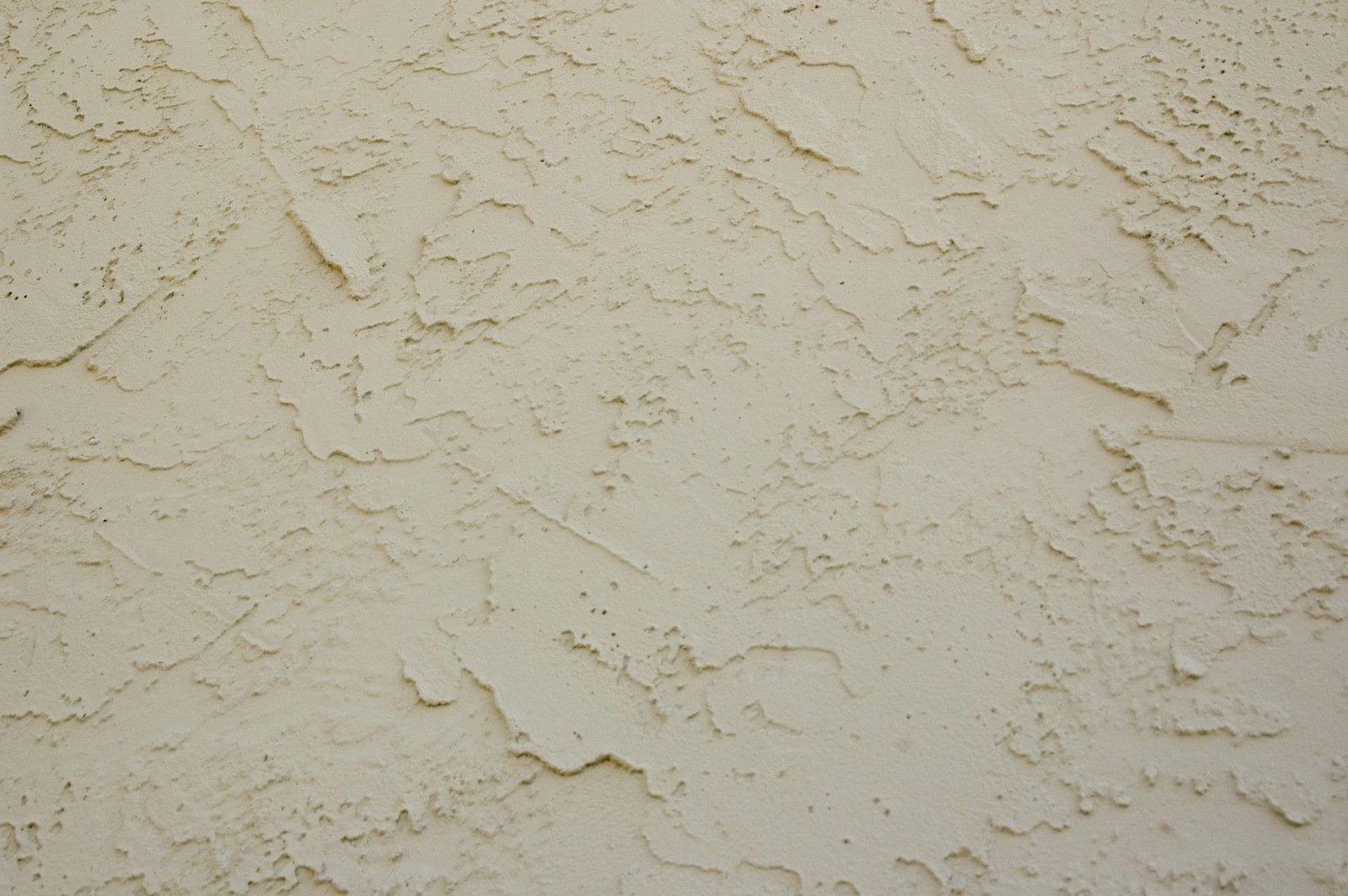 a close up of a paint covered wall with peeling white paint
