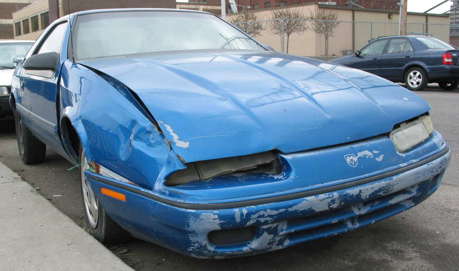 an upside down car parked on the curb