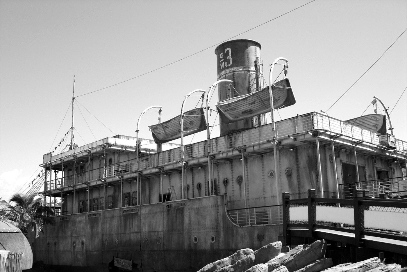 the large ship has two smaller boats by it