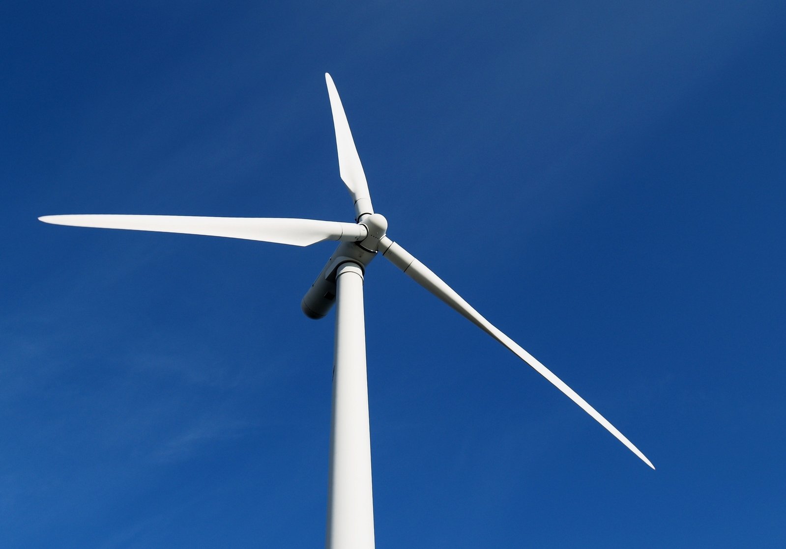 a wind turbine on a sunny day with blue sky