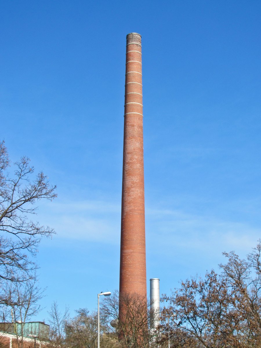 a brick building with a chimney in the middle of it