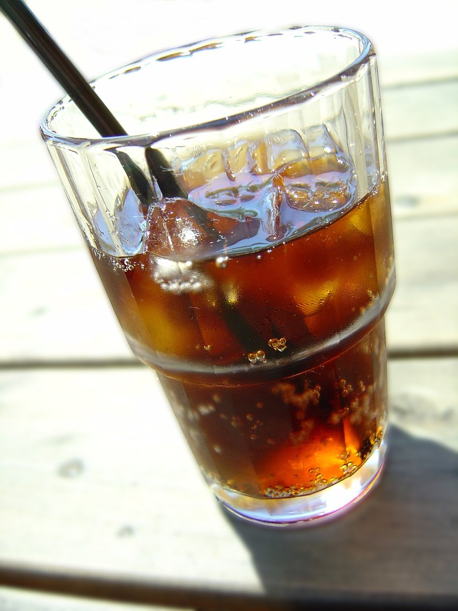 an iced drink sits on the wooden table