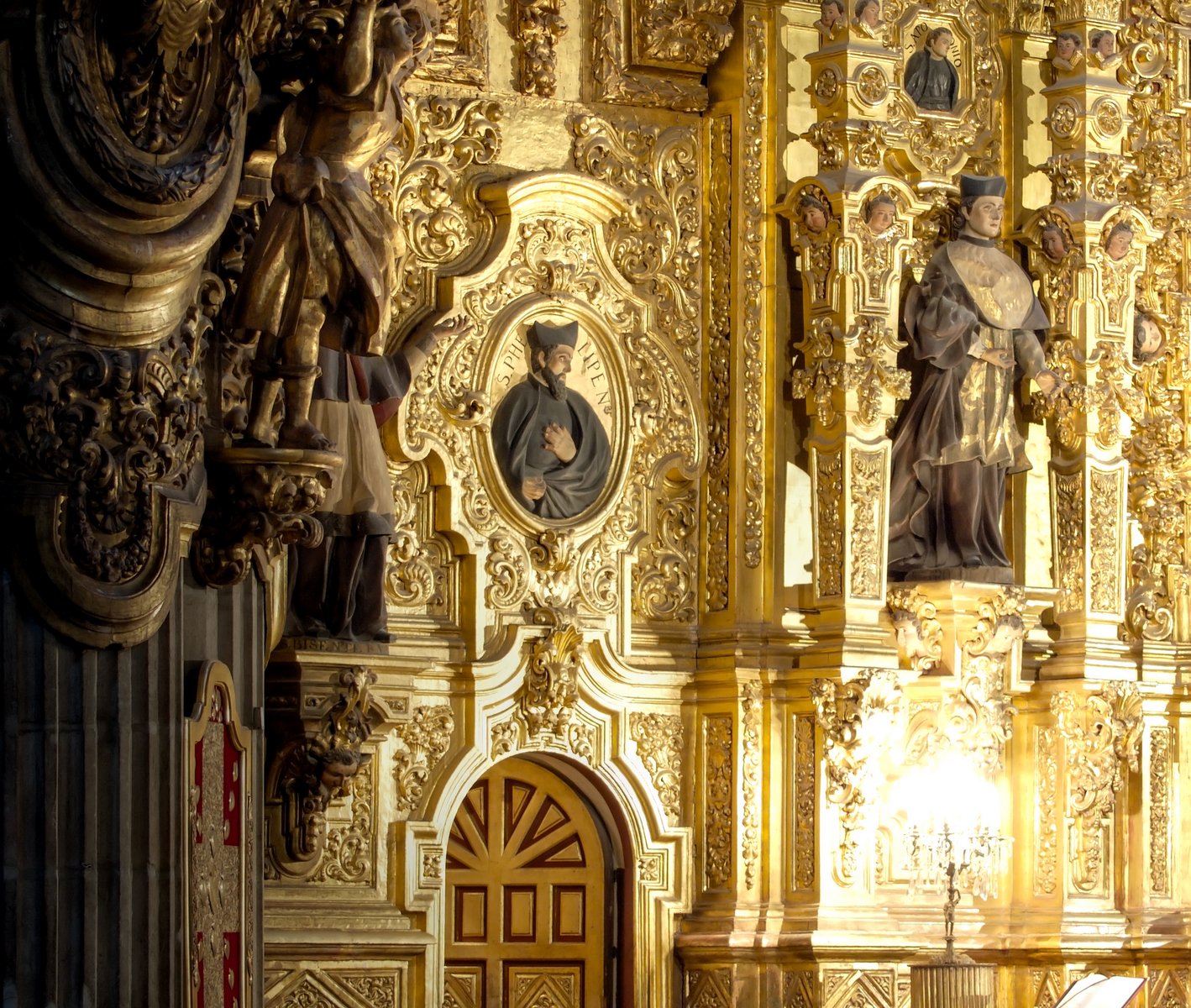 a close - up image of two statues in a golden church
