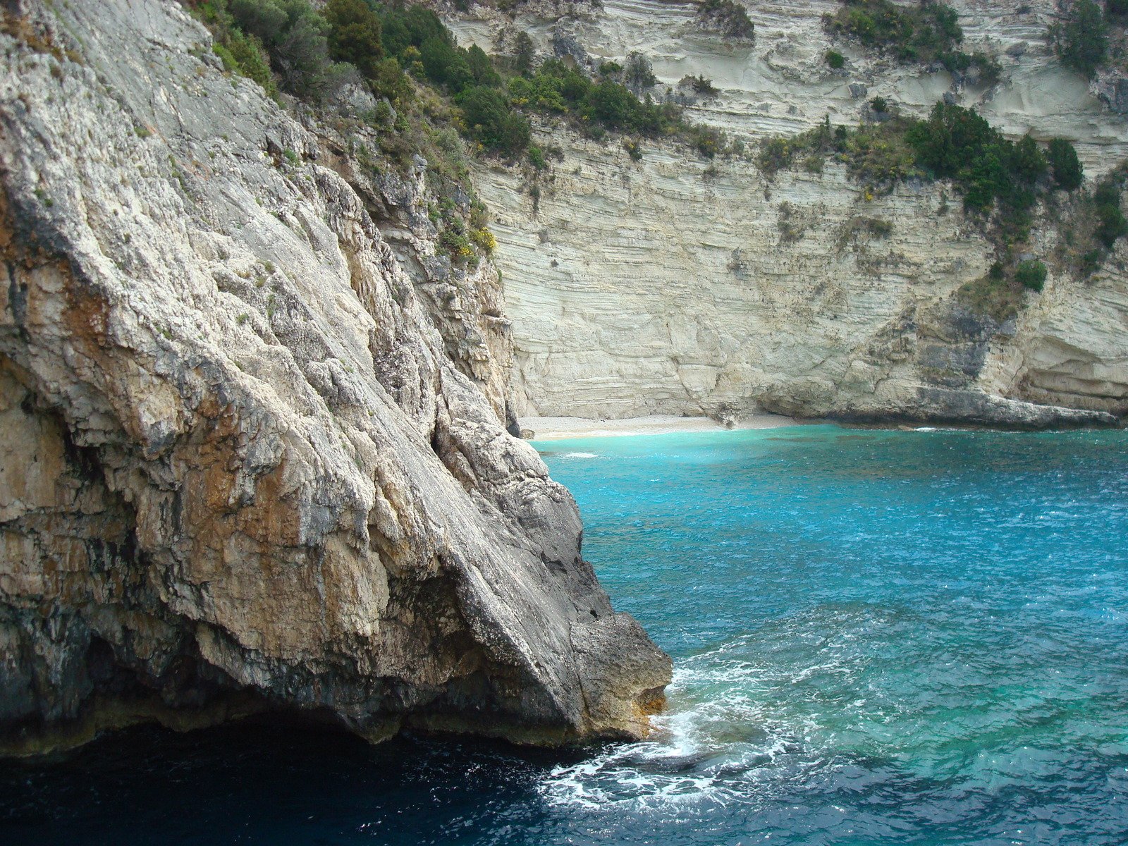 large chunk of rock with water below it