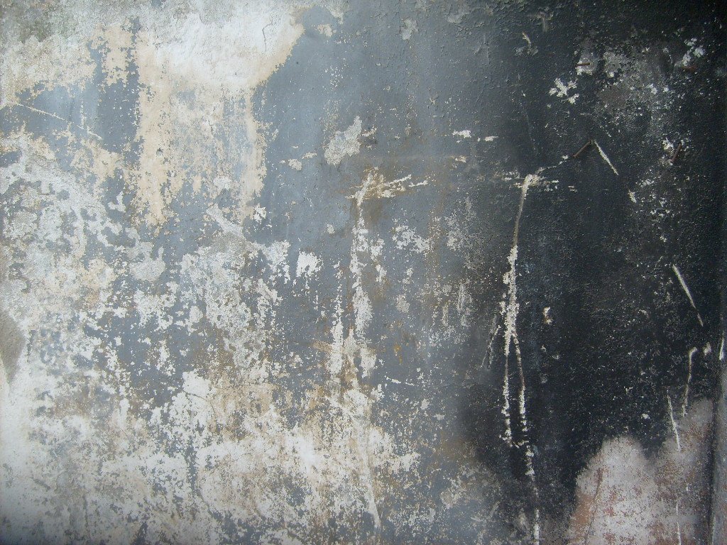 a dirty wall that is grungy and white