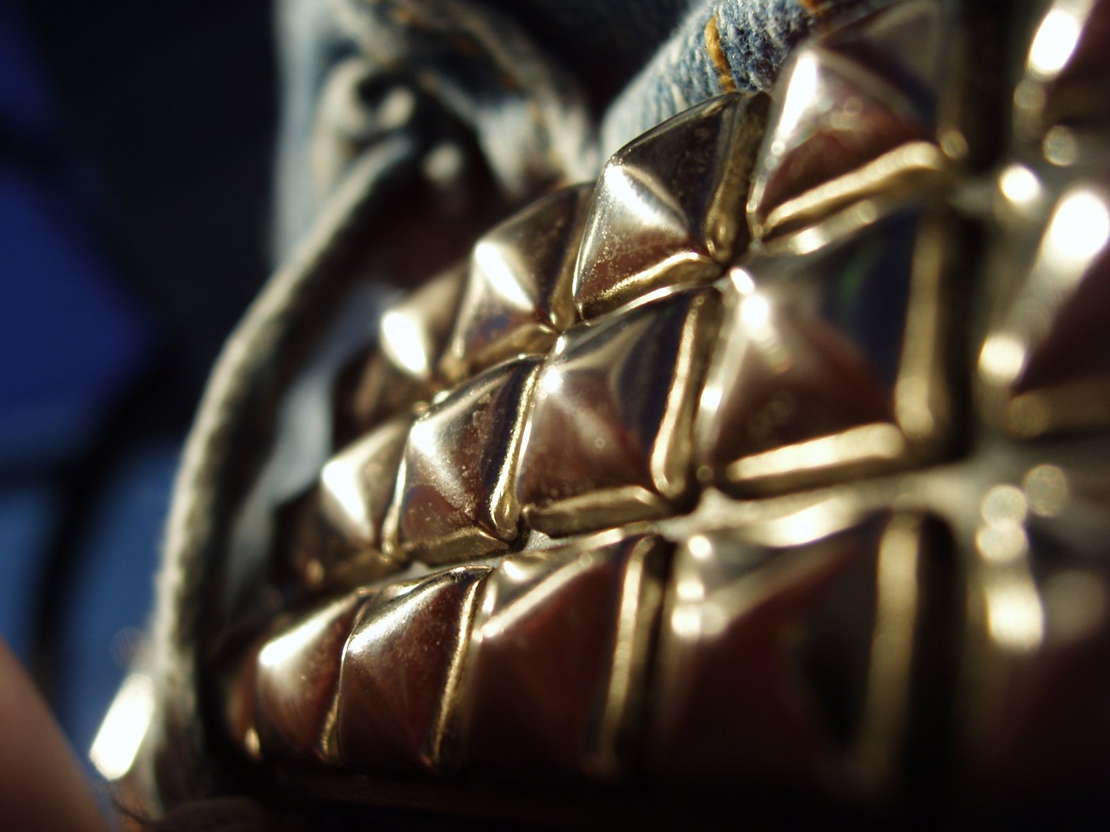 gold metallic material being held up in a basket