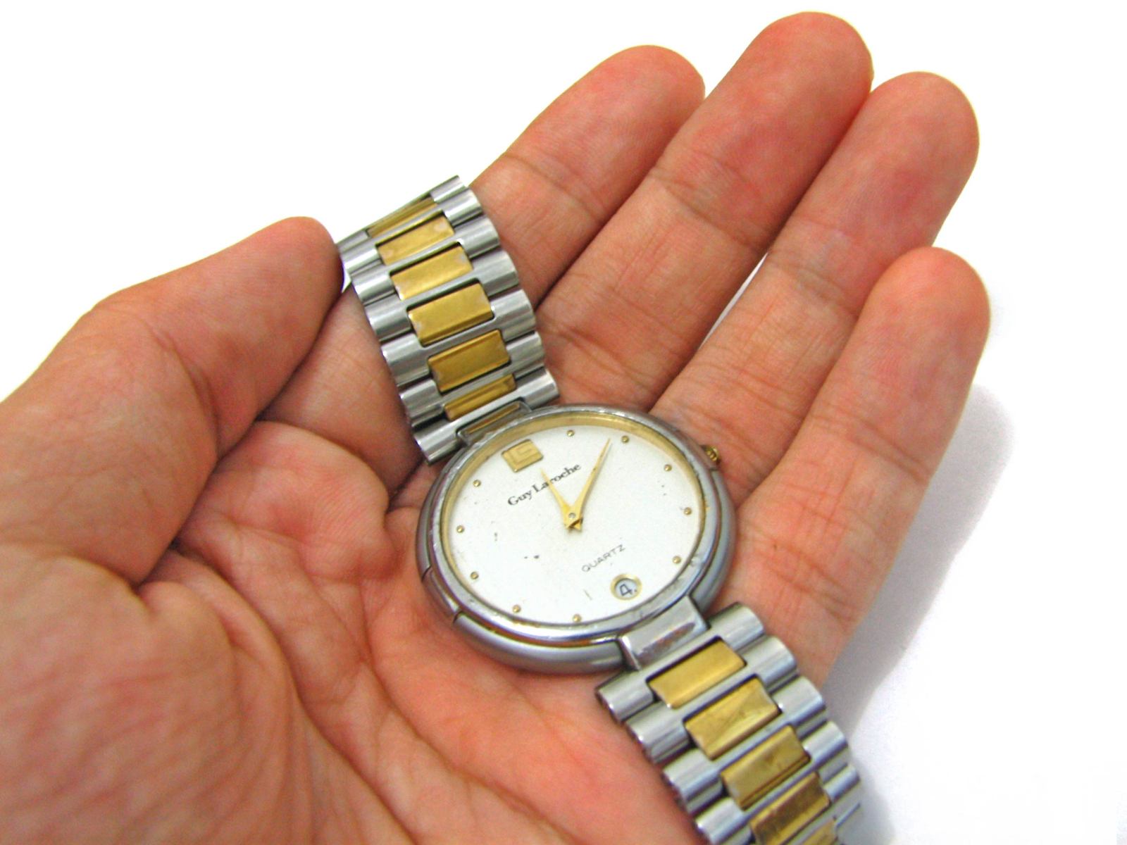 a man is holding a watch in his hands