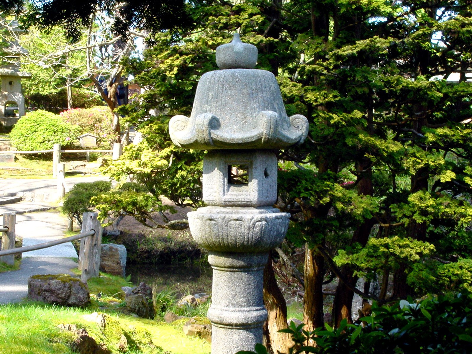 a stone sculpture surrounded by trees and rocks