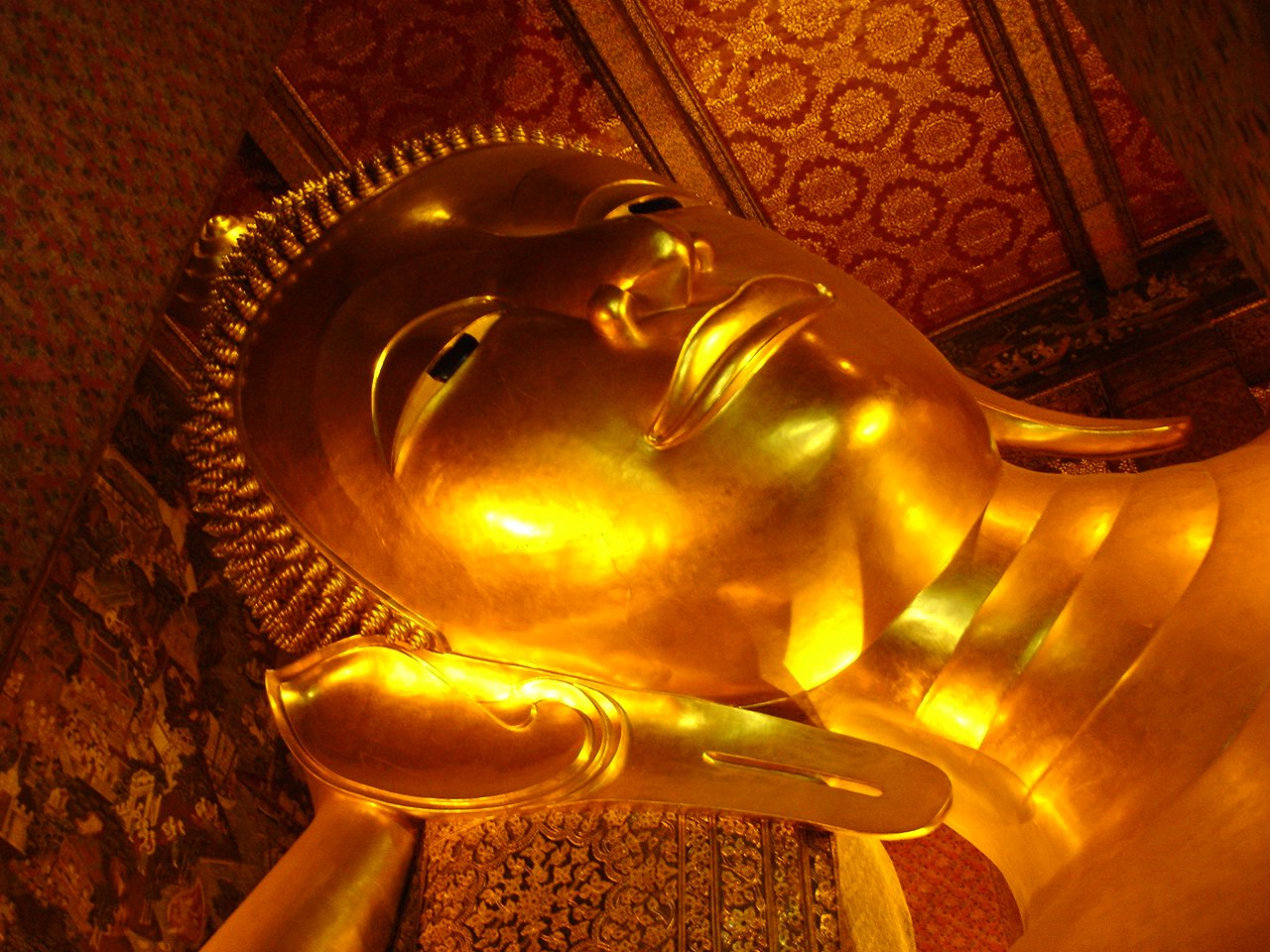 a big gold buddha statue in a room