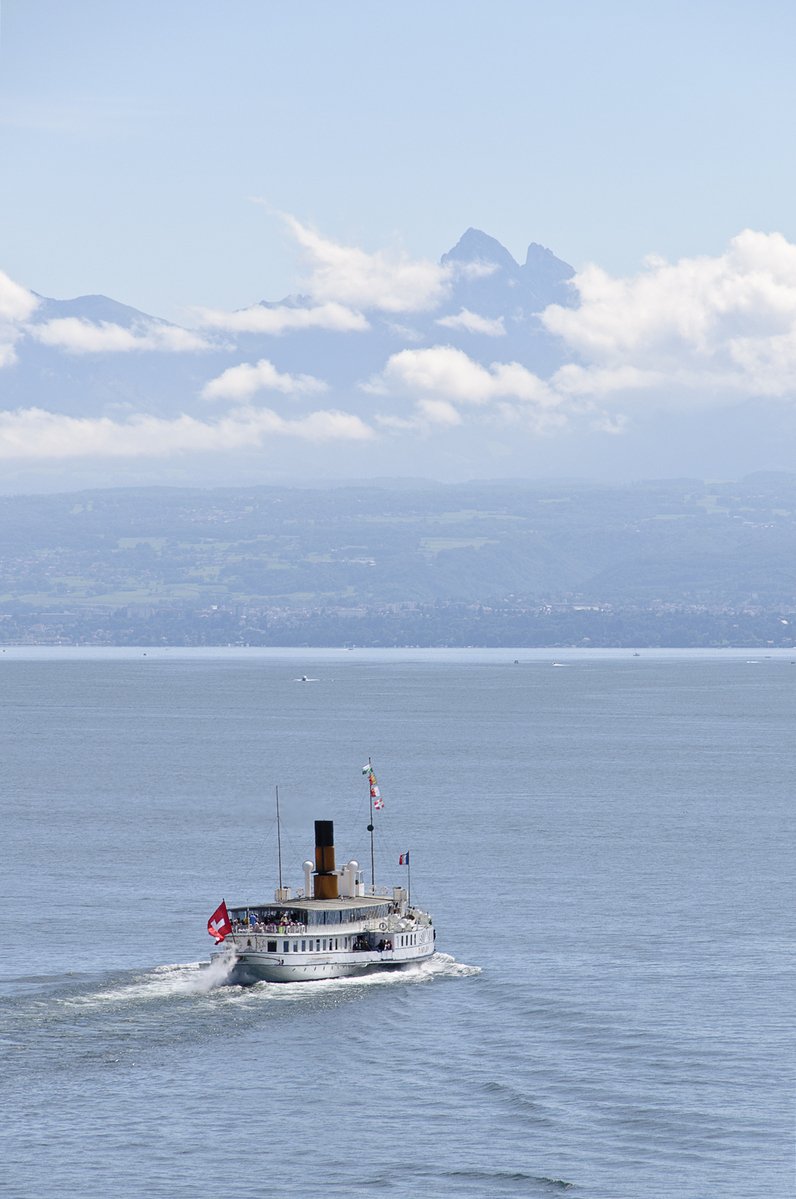 a ferry traveling across the water off into the distance