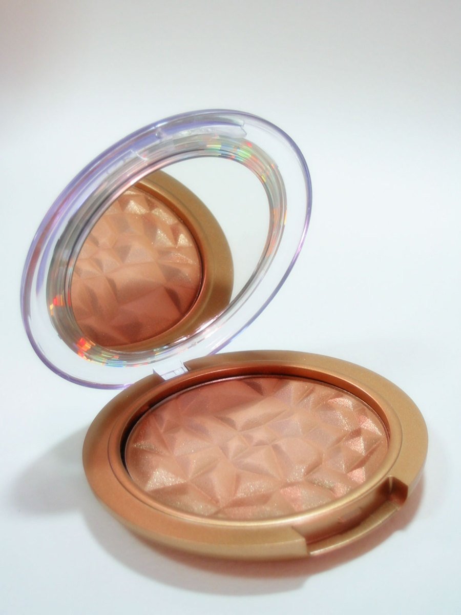 two round powder mirrors sitting next to each other