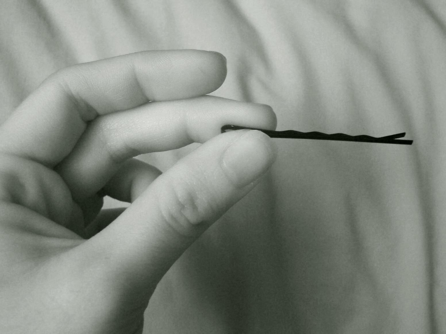 a person holding a black piece of string in their hand