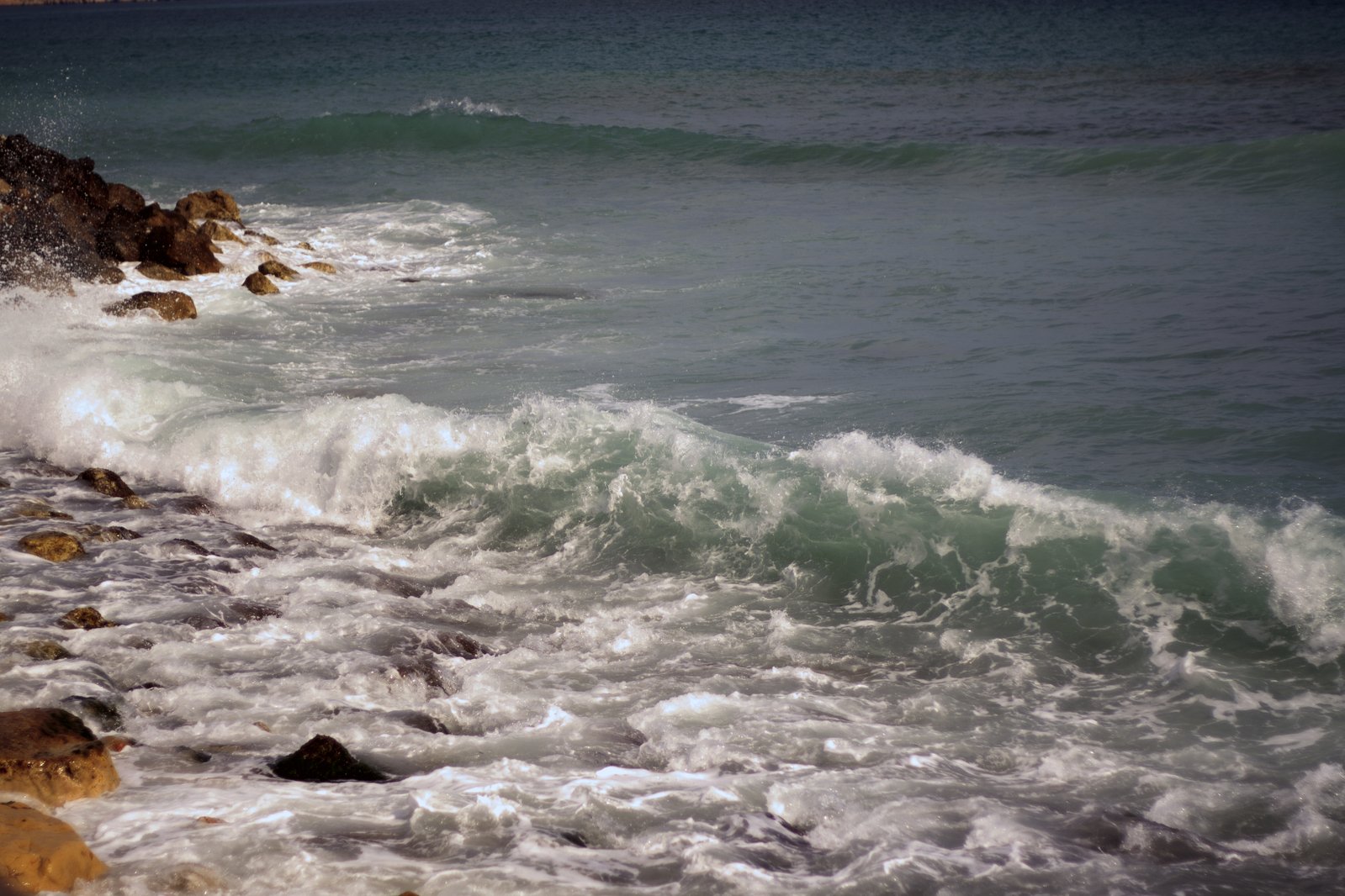 a man on surfboard riding waves in the ocean