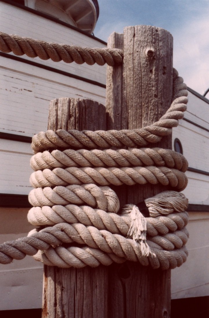 a rope that is hanging on a wooden pole
