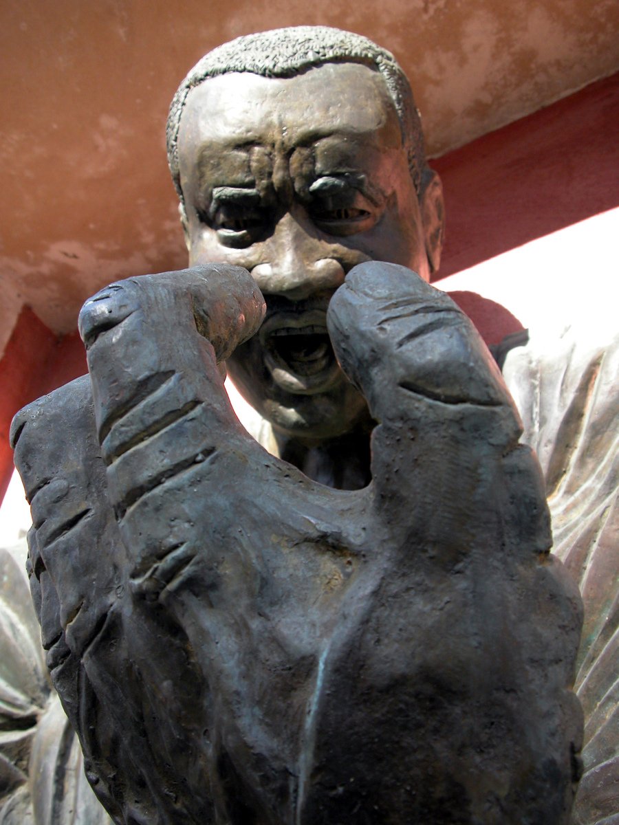 a close up of a statue of a person holding a piece of a human