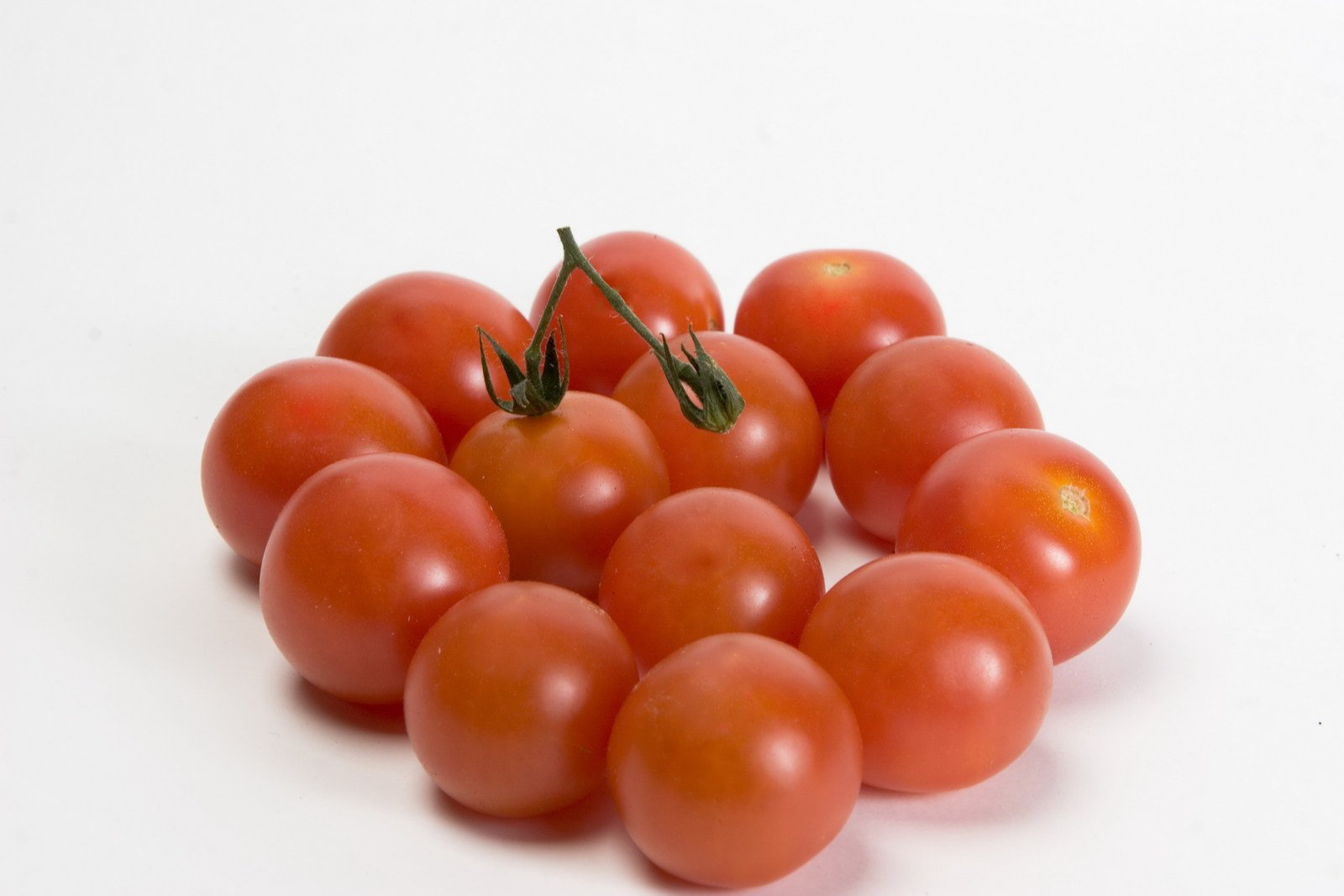 several tomatoes have been placed on a white surface