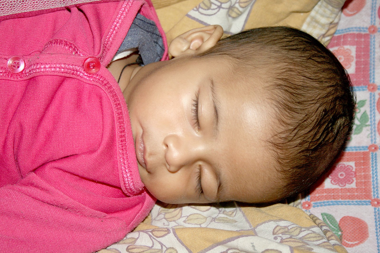 a child with a backpack sleeping on top of it