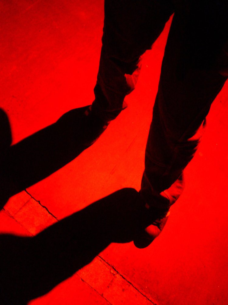 the shadow of a person on a red background