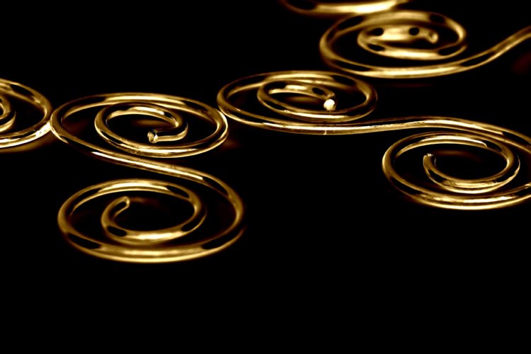 an abstract pograph of several wavy gold curls