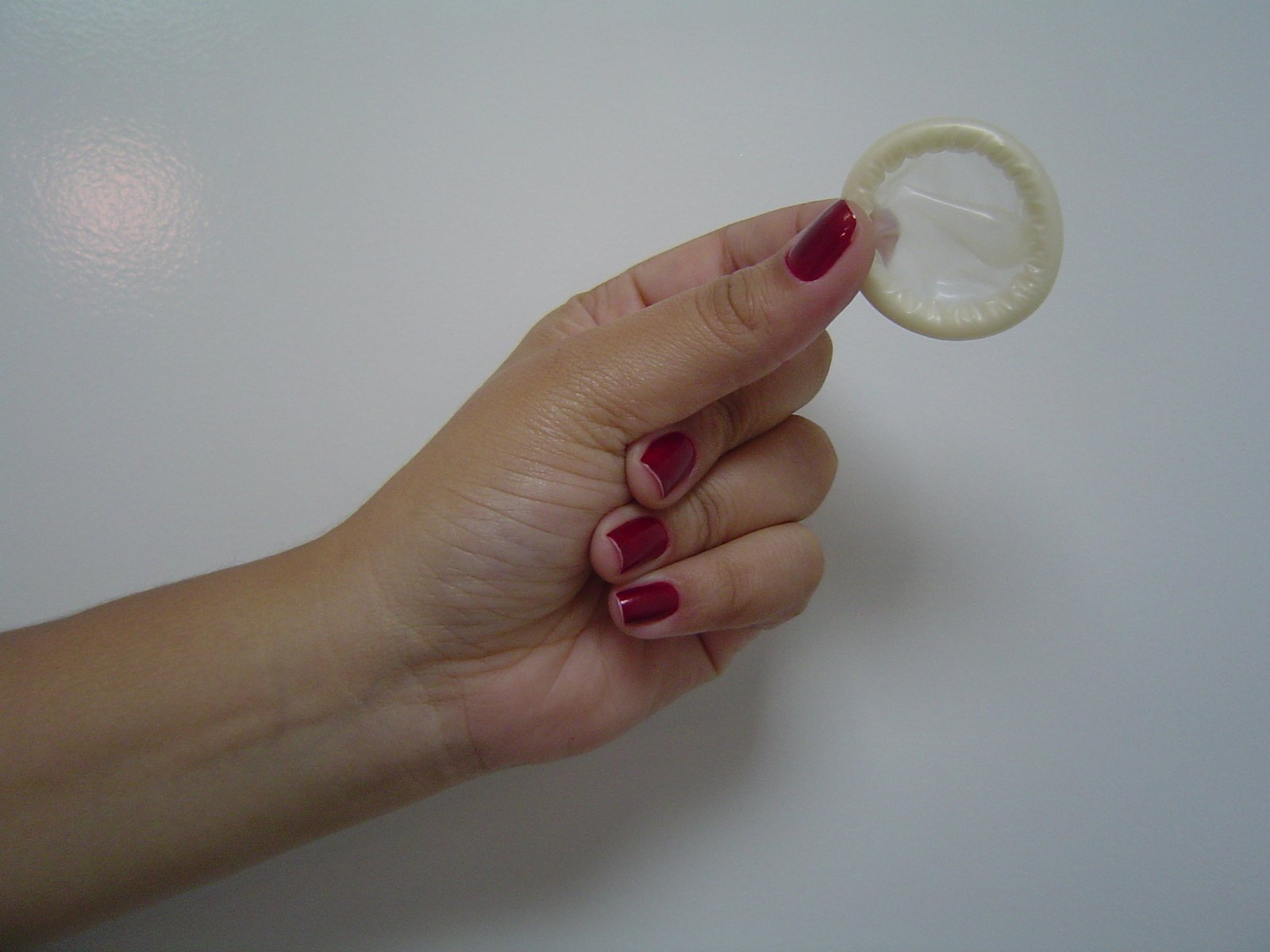 a white table with some hand holding a round object