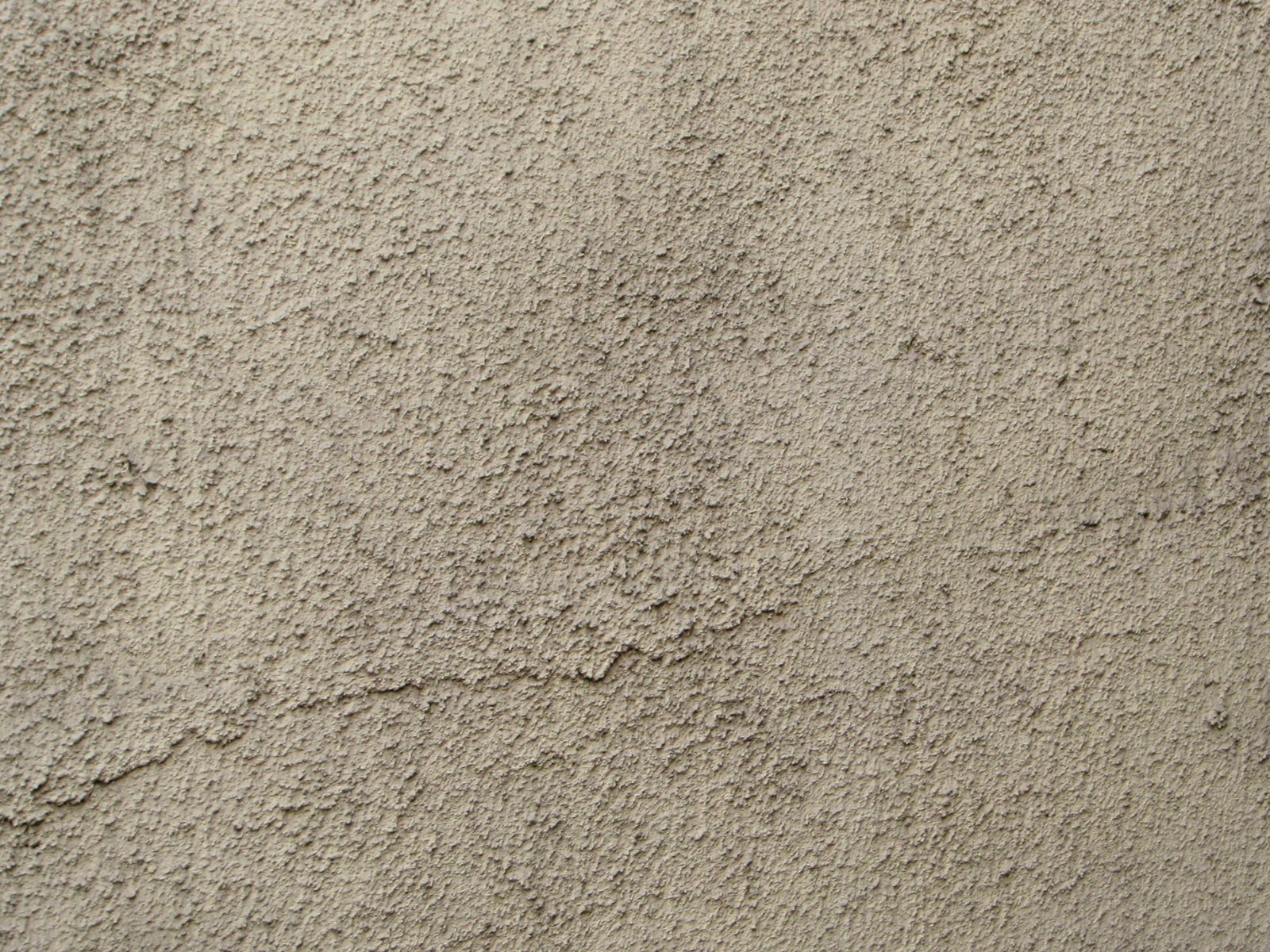 a white wall covered in lots of sand