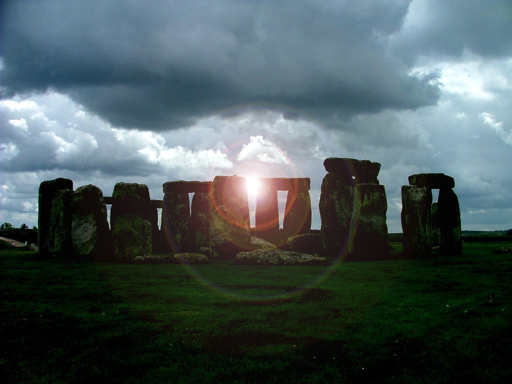 the sun shines brightly through stones in an ancient place