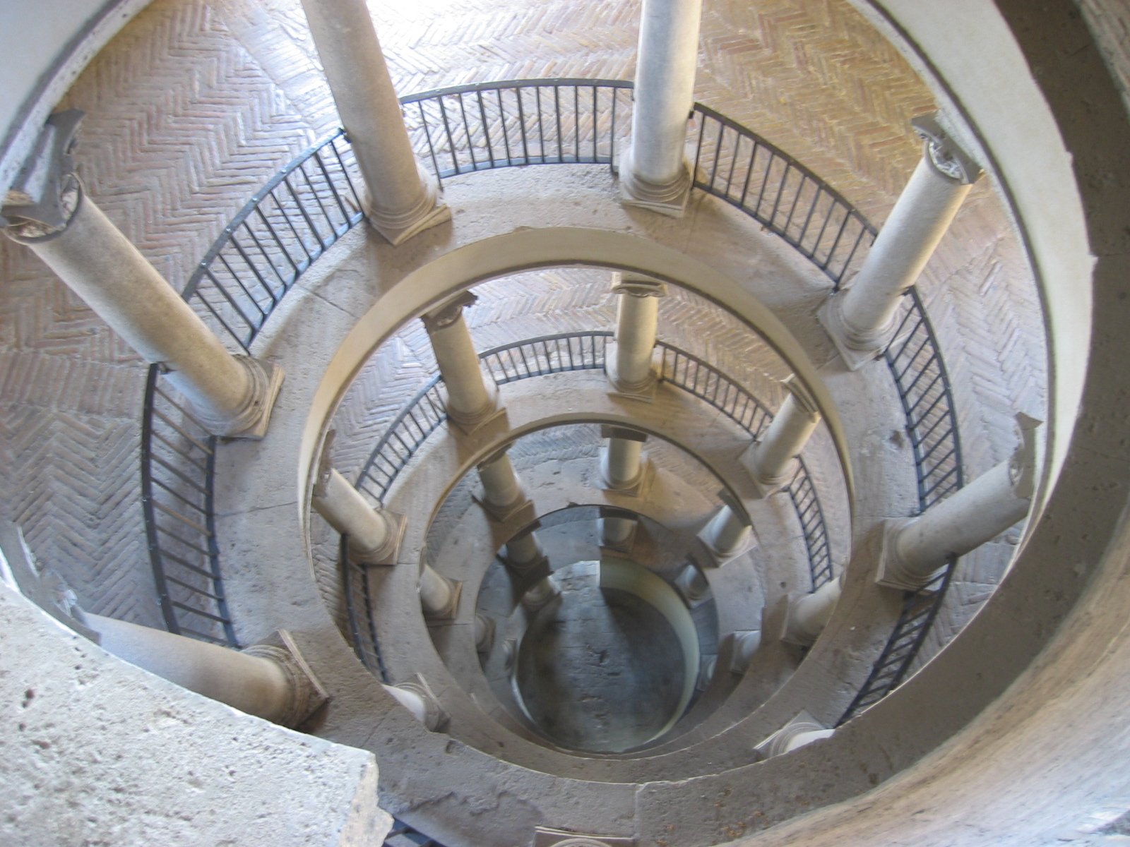 view of an iron pipe in the ceiling of a stairwell