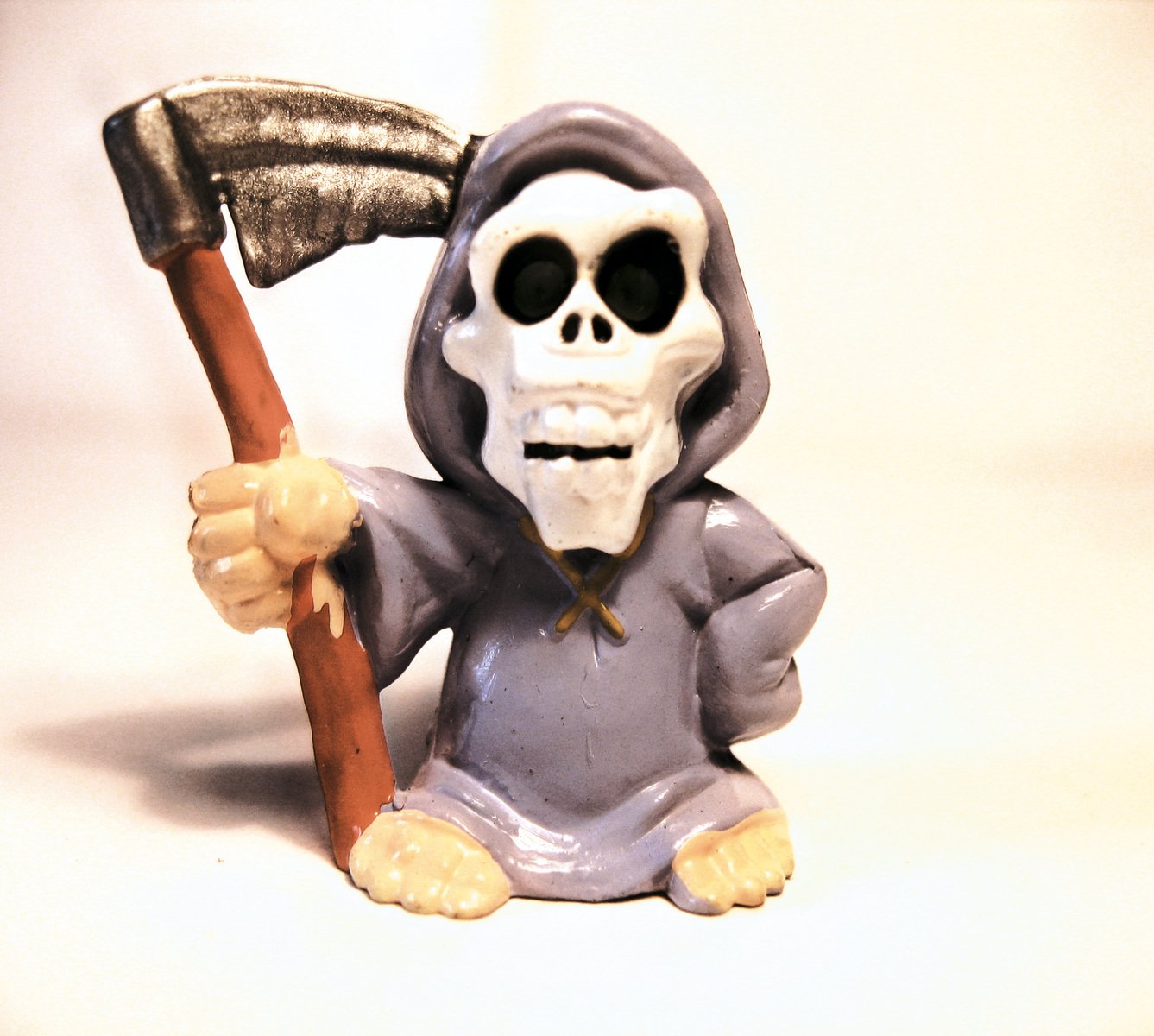 a toy figure holding an axe, which is sitting on the ground