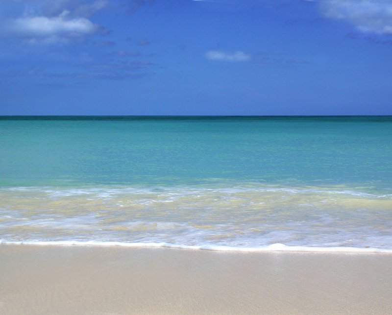 blue and green water with beach and white sand