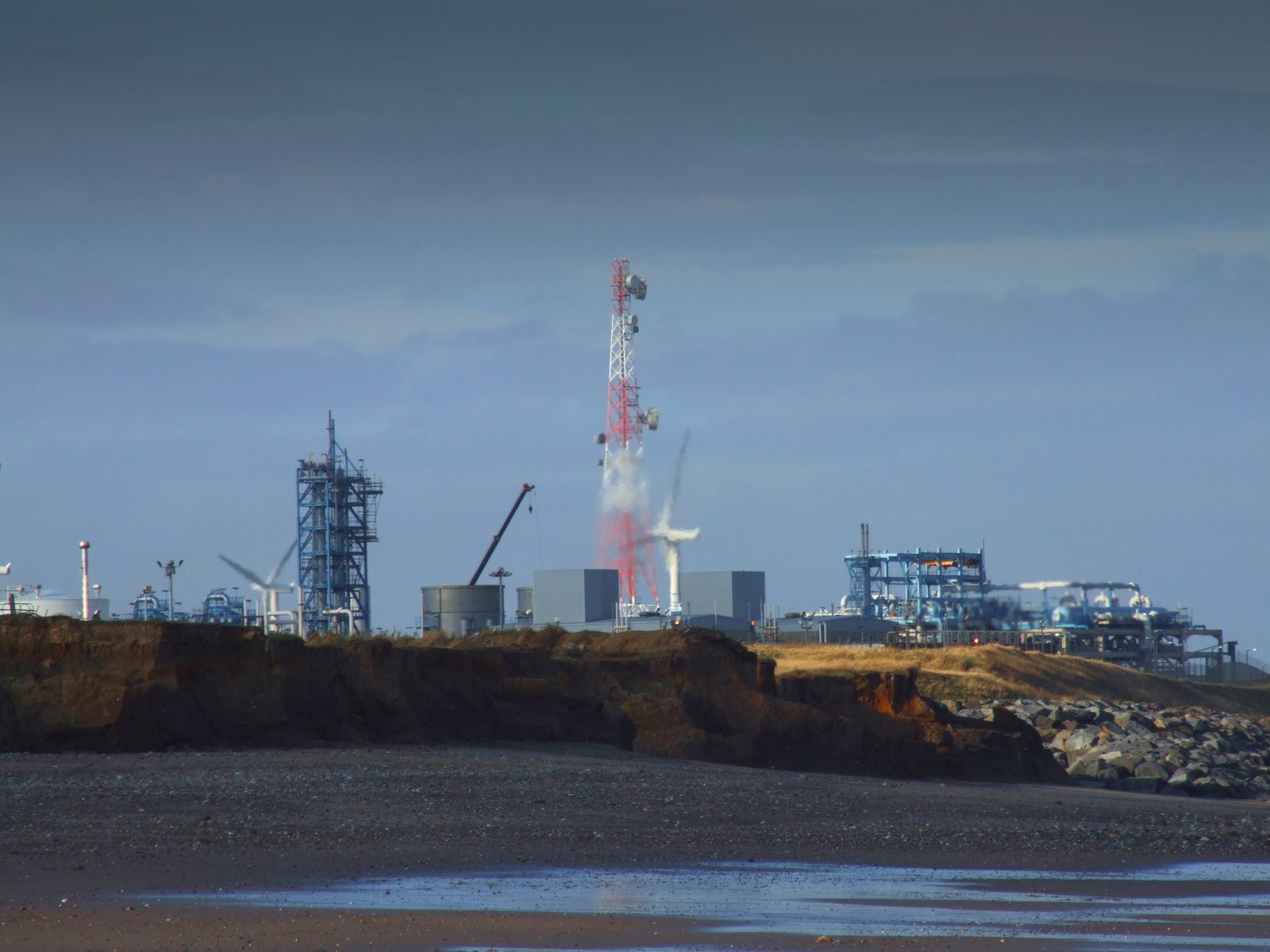 a power plant rising above a body of water