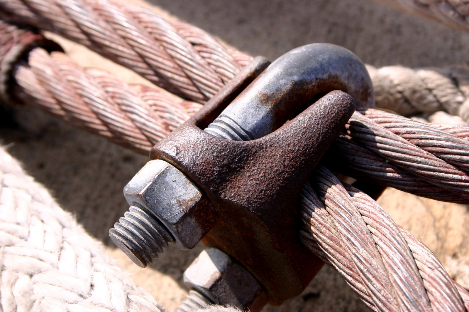 the rope and shacks of a ship anchor are rusted