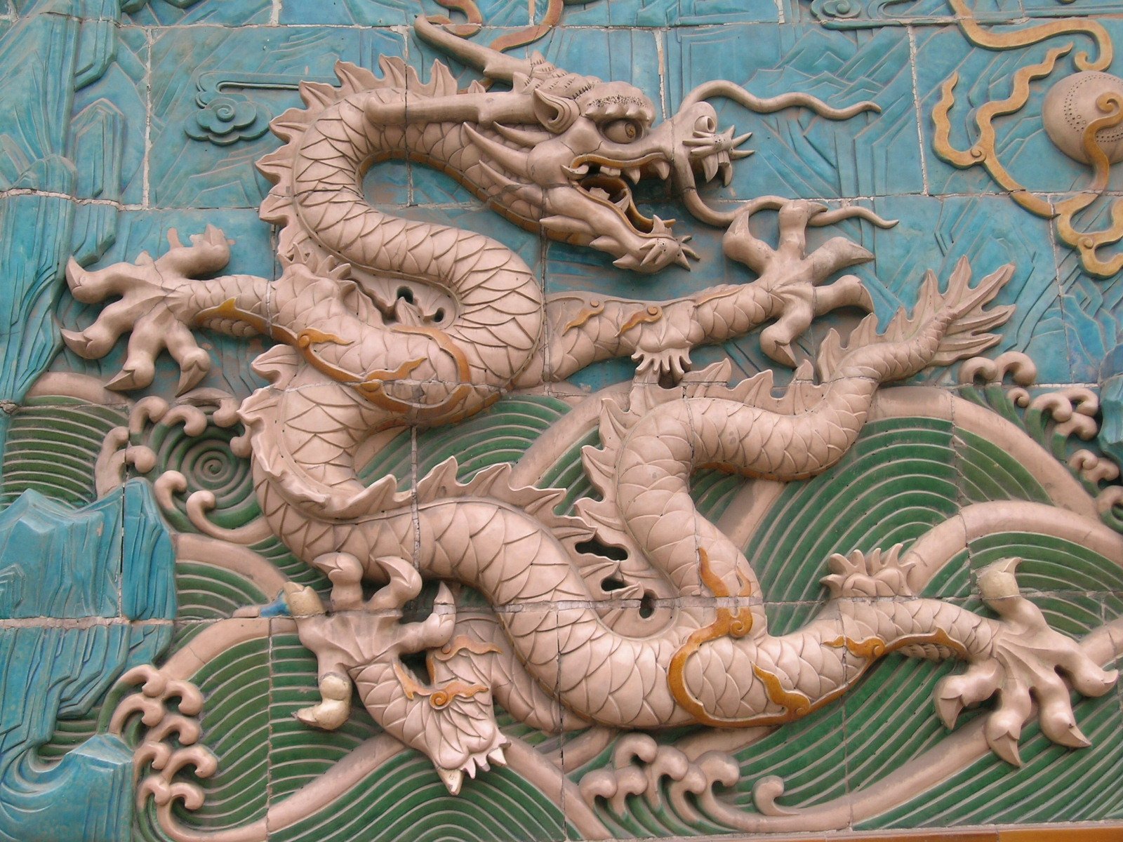 a decorative wall with dragon design on it