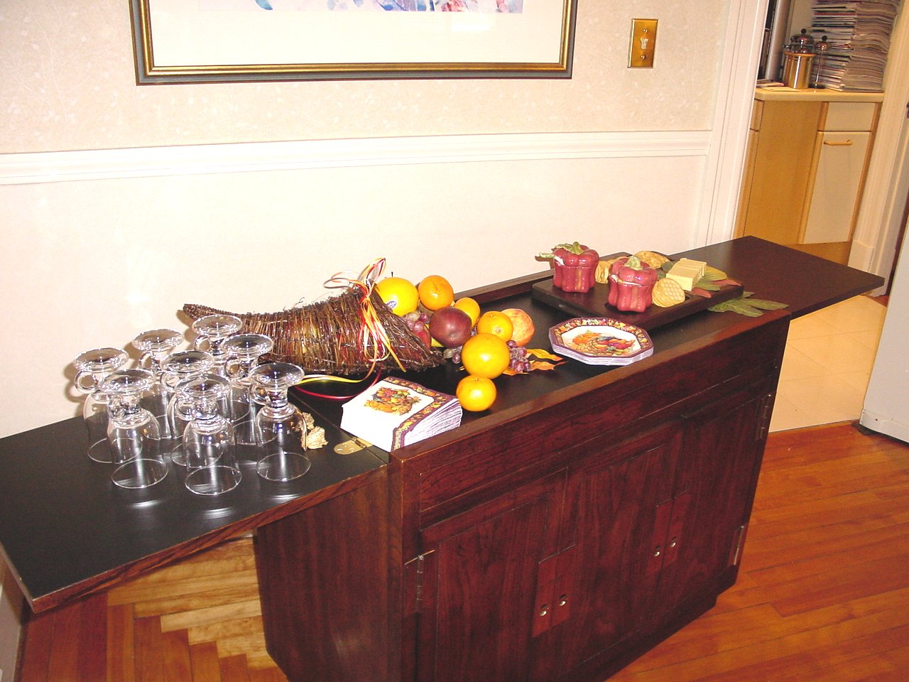 two wine glasses on top of a table with food