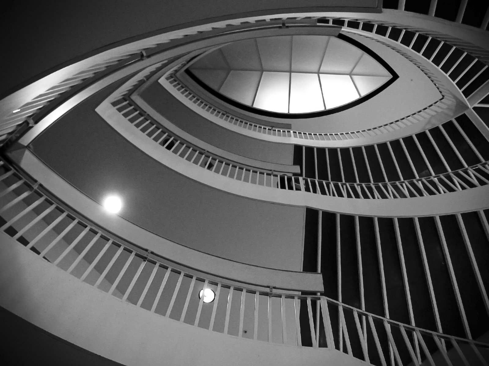 the interior staircase of a building with circular railings